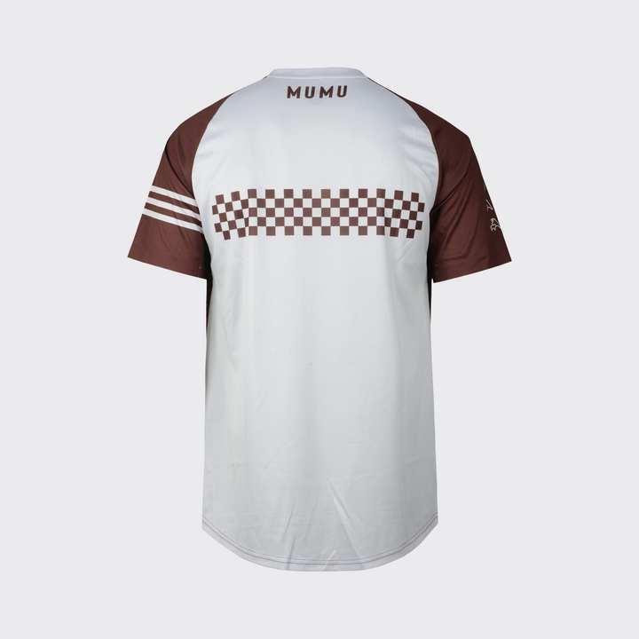 White and brown short-sleeve MTB jersey shown from the back, featuring a relaxed fit, brown sleeves, a brown checkered graphic across the upper back, three white sleeve stripes, brown MUMU branding below the collar, and a slightly extended rear hem, shown against a light gray background.
