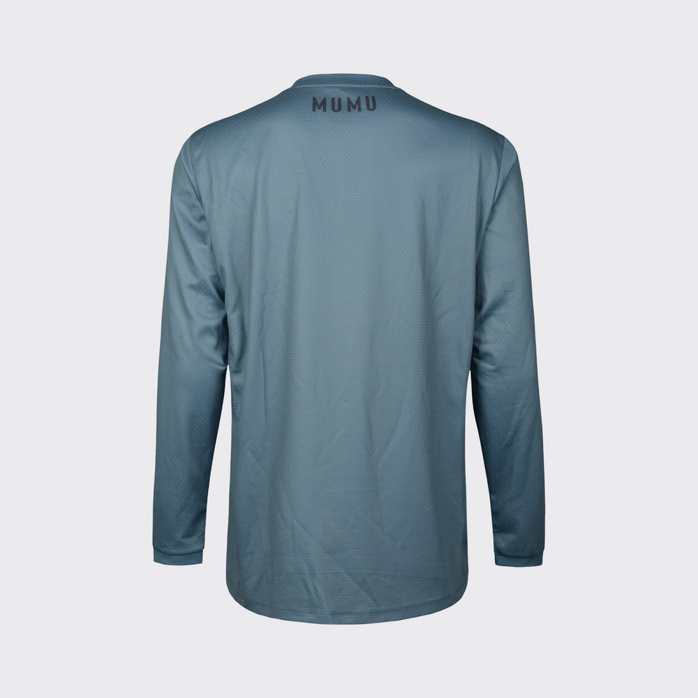 Slate blue long-sleeve MTB jersey shown from the back, featuring a relaxed fit, subtle textured performance fabric, long sleeves, and black MUMU branding centered below the collar, shown against a light gray background.
