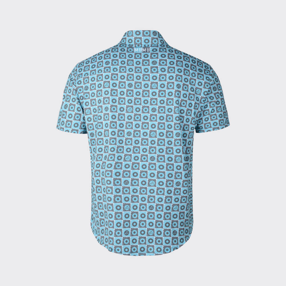 Back view of a short-sleeve MUMU button-down shirt with an all-over blue and gray geometric floral pattern and white MUMU branding centered below the collar.