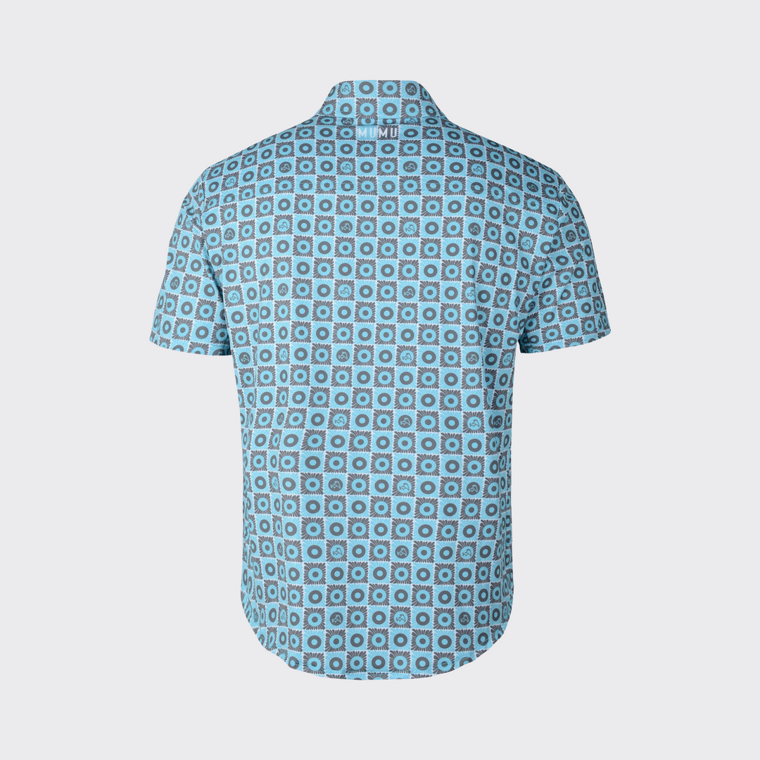 Back view of a short-sleeve MUMU button-down shirt with an all-over blue and gray geometric floral pattern and white MUMU branding centered below the collar.